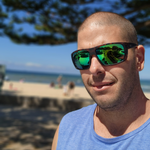 Fisherman having a break on the beach wearing his BARB Fishing Sunglasses - Rubber Demi Green Mirror